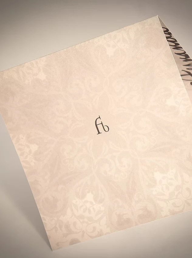 Fernanda Bernardo Jóias stationery on pink paper with arabesques and the fb monogram at the centre.