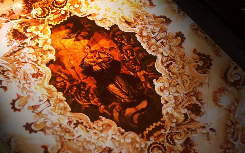 Publication page with a gilded baroque frame on a dark background.